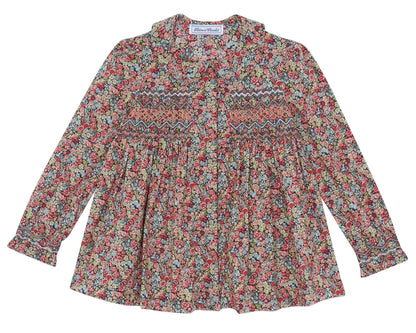 The Tartine et Chocolat Girls' Liberty Smocked Floral Tunic features long sleeves, a vibrant all-over Liberty floral print, and smocked detailing on the chest and upper arms.