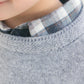 Close-up of a child in the Tartine et Chocolat Boys' Grey China Wool TC Signature Pullover Sweater over a blue and white plaid shirt, highlighting their face and the cozy wool sweater details.