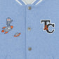 The Tartine et Chocolat Baby Boys' and Boys' Easy Bomber Cardigan features a light blue bomber style, white-striped collar, metallic buttons, and front embroidered patches of a robot, rocket, planet, and "T&C" logo.
