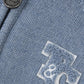 Close-up of the Tartine et Chocolat Baby Boys' and Boys' TC Signature Knit Zip Jacket, featuring a blue-grey knit, zipper with round metallic pull, and textured "C" and "8" appliqué—perfect for stylish layering.