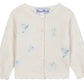 The Tartine et Chocolat Baby Girls' and Girls' Emeraude Embroidery Floral Cardigan features a cream color, front buttons, and delicate light blue floral embroidery.