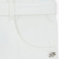 Close-up of Tartine et Chocolat Girls' Drawstring Bow Trousers in ivory, featuring a pocket, belt loop, and a small metallic decorative pin near the tie-up bow.