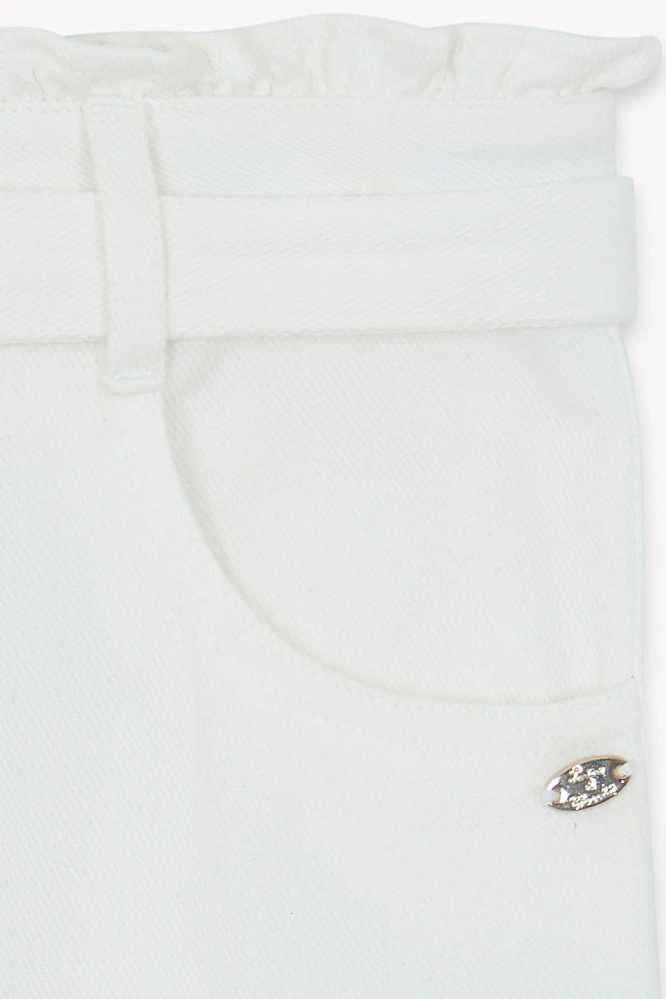 Close-up of Tartine et Chocolat Girls' Drawstring Bow Trousers in ivory, featuring a pocket, belt loop, and a small metallic decorative pin near the tie-up bow.