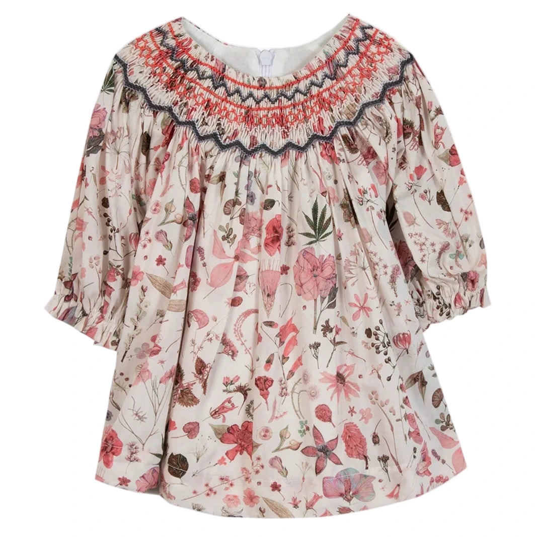 Tartine et Chocolat's Baby Girls' and Girls' Smocked Collar Floral Dress features a charming floral and mushroom print on soft Liberty fabric, with a multicolored smocked neckline for added style.