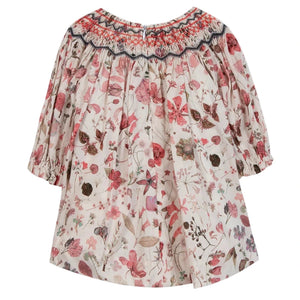 The Tartine et Chocolat Baby Girls' and Girls' Smocked Collar Floral Dress features a pink and red floral print with smocked details at the collar and cuffs, crafted from Liberty fabric.