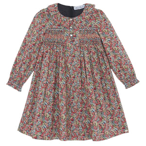 The Tartine et Chocolat Girls' Liberty Smocked Ruffle Sleeved Floral Dress features a vibrant Liberty print, smocked chest, ruffled sleeves and collar, plus front buttons for easy dressing.