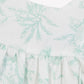 Close-up of Tartine et Chocolat Baby Girls' and Girls' Puff Sleeve Dress, showcasing white fabric with a light green botanical print and gathered stitching below the yoke.