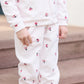 A girl wears the Tartine et Chocolat Baby Girls' and Girls' Velvet Hooded Jogger Set while standing on carpeted steps.