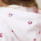 Close-up of a girl wearing the Tartine et Chocolat Baby Girls' and Girls' Velvet Hooded Jogger Set in light pink, featuring delicate embroidered floral details on the hood.