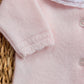 Close-up of Tartine et Chocolat Baby Girls' Ruffle Collar Long Sleeved Outfit in pale pink wool-cashmere knit with white buttons; the collar has white fabric and delicate pink floral embroidery—ideal for newborns.