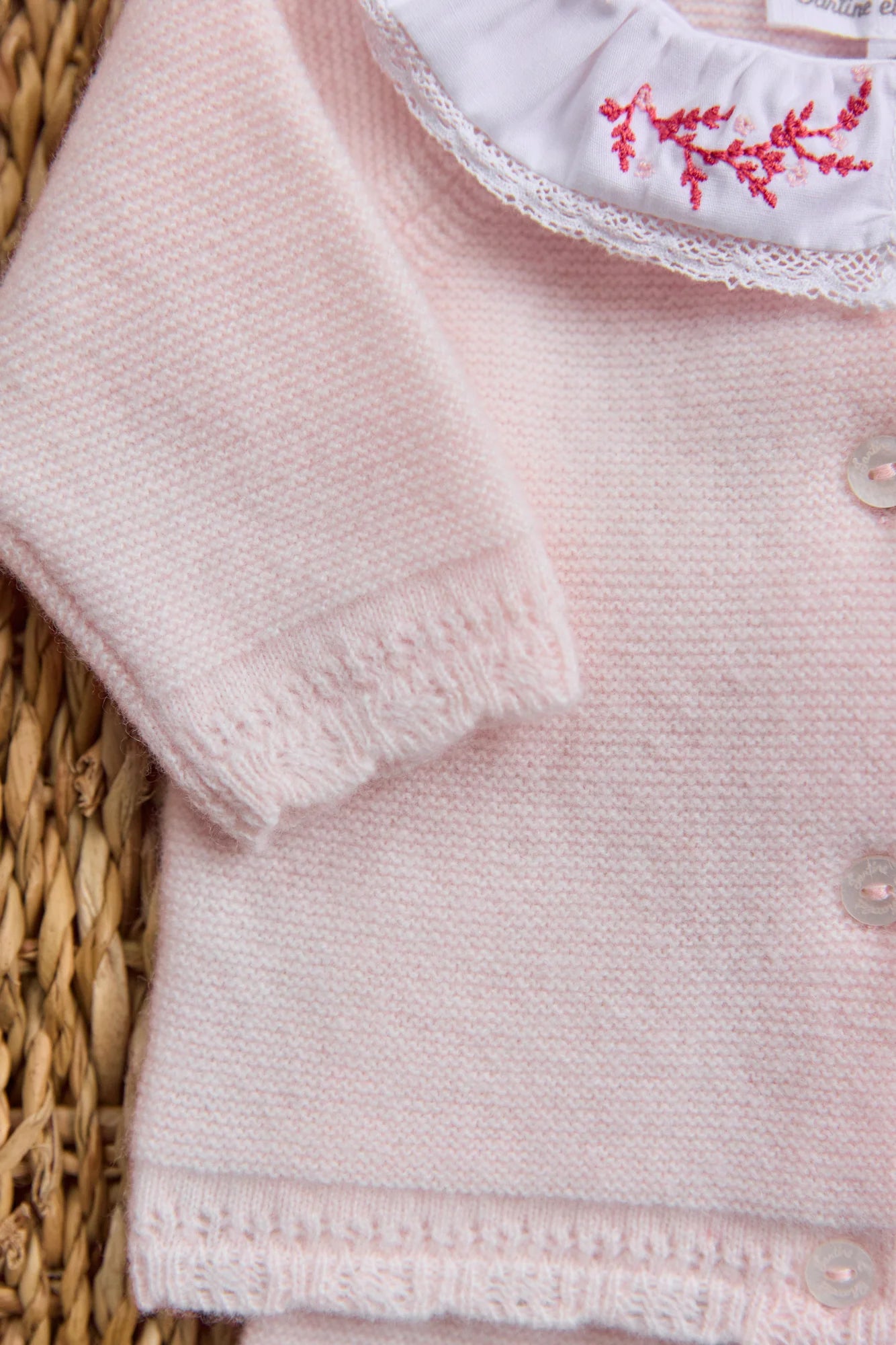 Close-up of Tartine et Chocolat Baby Girls' Ruffle Collar Long Sleeved Outfit in pale pink wool-cashmere knit with white buttons; the collar has white fabric and delicate pink floral embroidery—ideal for newborns.