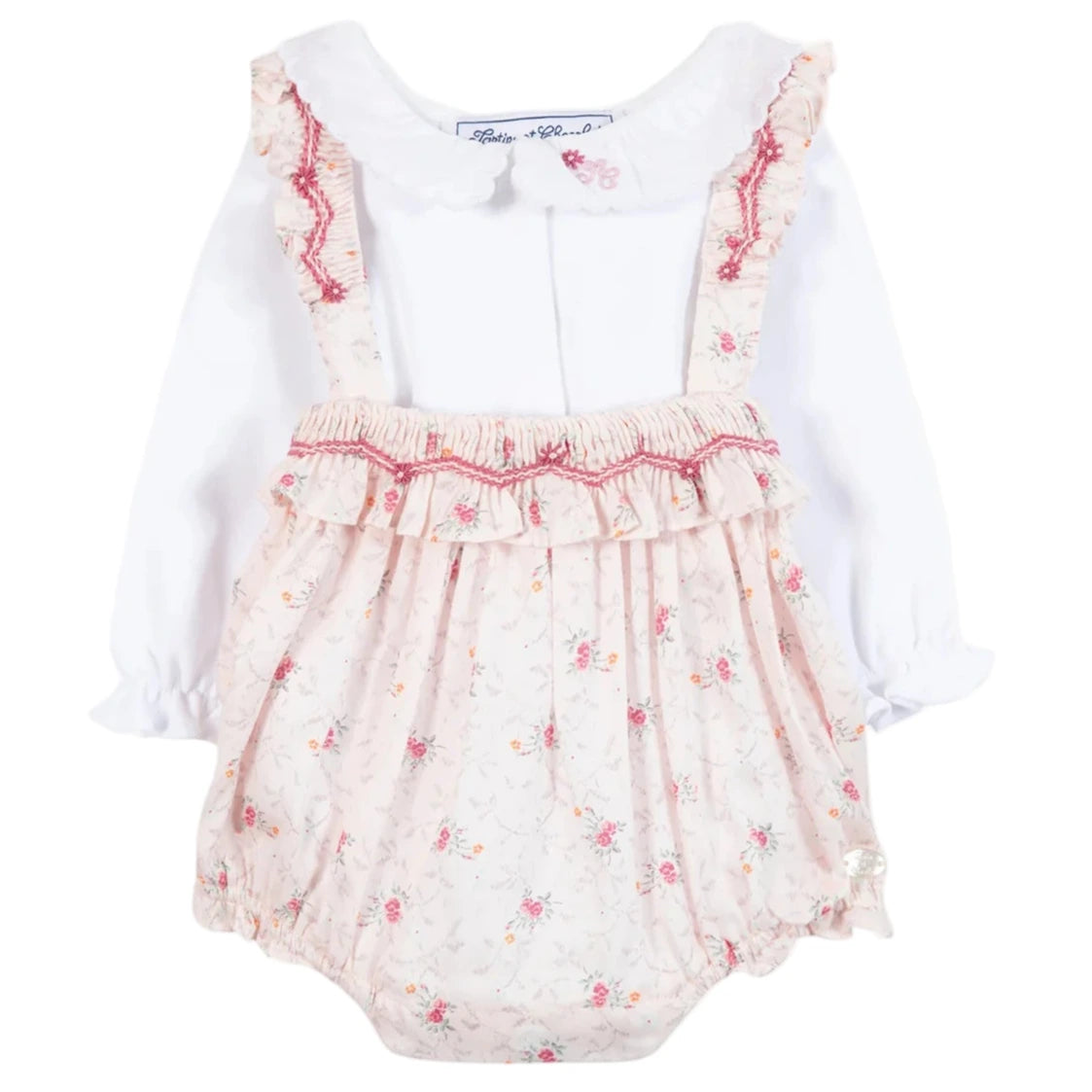 The Tartine et Chocolat Baby Girls' Overall Outfit includes a long-sleeve white ruffled collar bodysuit and a floral-patterned pink suspender skirt with lace and red trim.