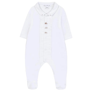 Dress your baby boy in these white long-sleeve footed pajamas from Tartine et Chocolat, featuring a pleated front, silver buttons, a rounded collar, and cute embroidered hedgehogs—Baby Boys' Hedgehog Pajamas.
