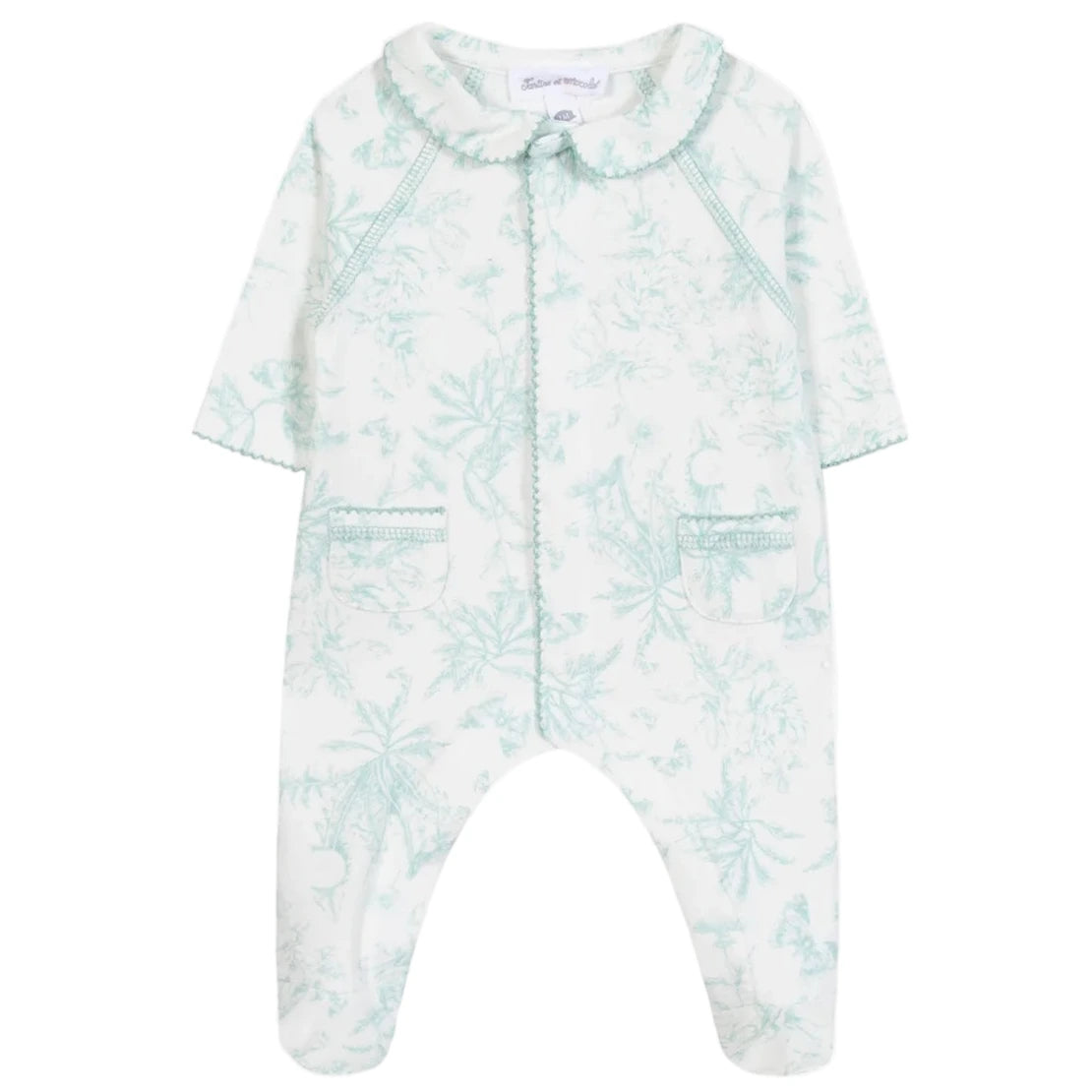 Tartine et Chocolat Baby Girls' Printed Pajamas feature long sleeves, a scalloped collar, two front pockets, and a light green Toile de Jouy-inspired botanical print on soft white fabric.