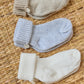 The Tartine et Chocolat Knit Sock 3-Pack features three pairs of cotton baby socks in beige, light blue, and white—perfect essentials for any nursery wardrobe.