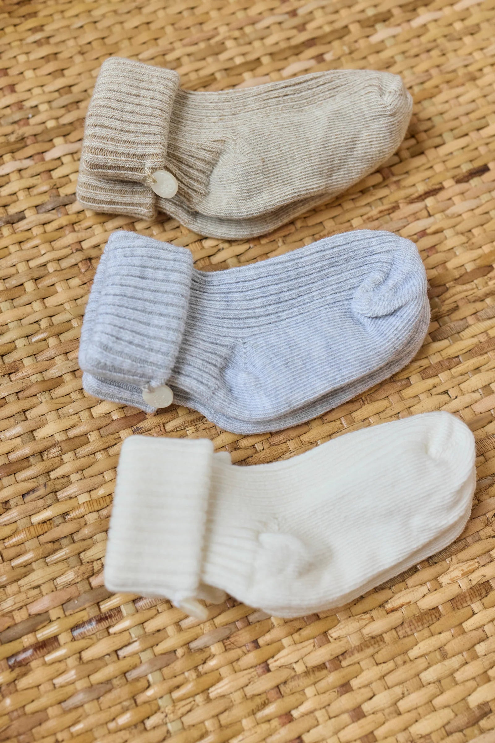 The Tartine et Chocolat Knit Sock 3-Pack features three pairs of cotton baby socks in beige, light blue, and white—perfect essentials for any nursery wardrobe.