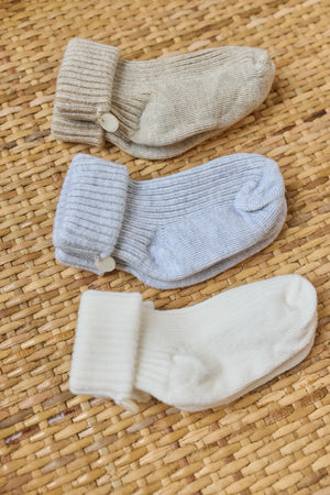 The Tartine et Chocolat Knit Sock 3-Pack features three pairs of cotton baby socks in beige, light blue, and white—perfect essentials for any nursery wardrobe.