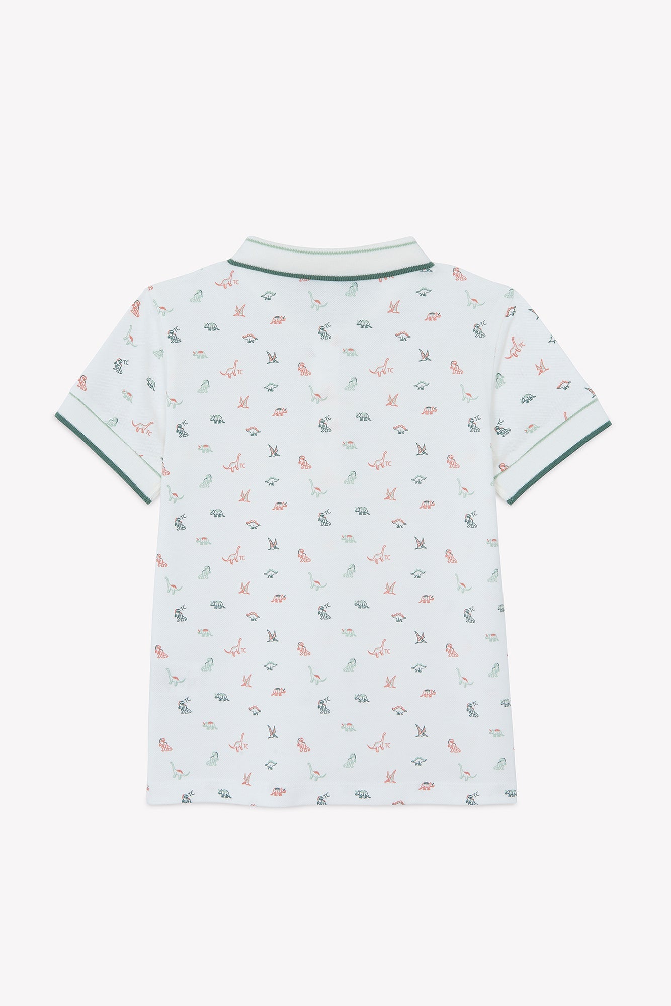 Tartine et Chocolat Baby Boys’ and Boys’ Knitted Polo Shirt, featuring short sleeves and a green collar with matching cuffs. This white cotton polo showcases an all-over print of dinosaurs, small red and green animals, and leafy accents for a playful look. Crafted from soft cotton for ultimate comfort. Back view shown.
