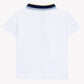 The Tartine et Chocolat Baby Boys’ and Boys’ Polo Shirt is shown from the back in white cotton, featuring a ribbed collar with navy blue and yellow striped trim.