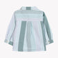 Tartine et Chocolat Baby Boys’ and Toddler Badge Shirt features long sleeves with buttoned cuffs, a classic collar, and vertical green and white stripes. Crafted from soft cotton for all-day comfort, this shirt is perfect for casual looks and is shown from the back against a white background.