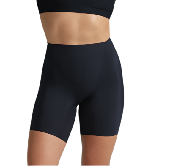 A person models Commando's Zone Smoothing Shorts—high-waisted black compression shorts—shown from midriff to mid-thigh against a white background.