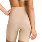 Model wearing Commando Zone Smoothing Shorts, a nude seamless high-waisted compression undergarment, shown from the back with one hand on hip.