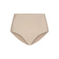 The Commando Zone Smoothing Brief is a beige high-waisted shapewear for women, featuring smoothing panels and a seamless design, shown against a plain white background.