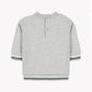 Showcased from the back, the Tartine et Chocolat Baby Boys’ and Boys’ Dinosaur Sweatshirt comes in a light heather grey shade and features snap buttons at the neck for easy dressing. Green and white striped trim accents the sleeves and hem, while its 100% cotton construction ensures everyday comfort for toddlers.