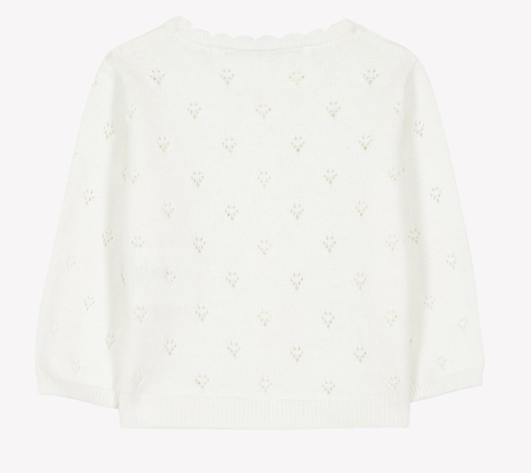 The Tartine et Chocolat Baby Girls’ and Girls’ Openwork Cardigan features a subtle repeating openwork pattern, long sleeves, and scalloped detailing along the neckline. Displayed flat against a plain background, this piece is perfect for layering and adds a delicate texture to any outfit.