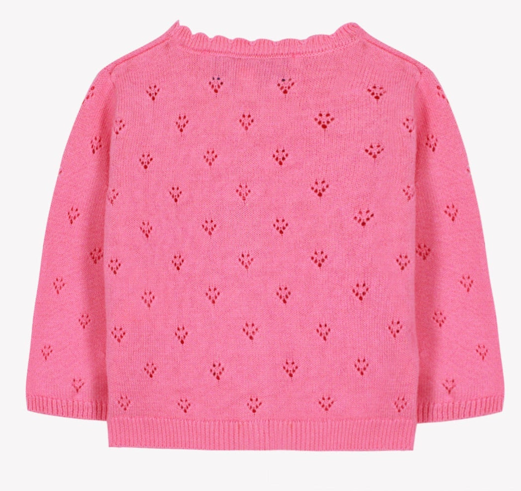 The Baby Girls’ and Girls’ Openwork Cardigan by Tartine et Chocolat features a pink knit design with small, evenly spaced heart-shaped eyelet patterns and long sleeves, displayed on a white background—a perfect layering piece that exudes delicate charm.