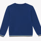 The Boys’ Illustration Sweater by Tartine et Chocolat is laid flat and viewed from the back. Made from 100% cotton, this blue long-sleeve sweater for kids features thin yellow, white, and light blue stripe accents on the cuffs and hem.