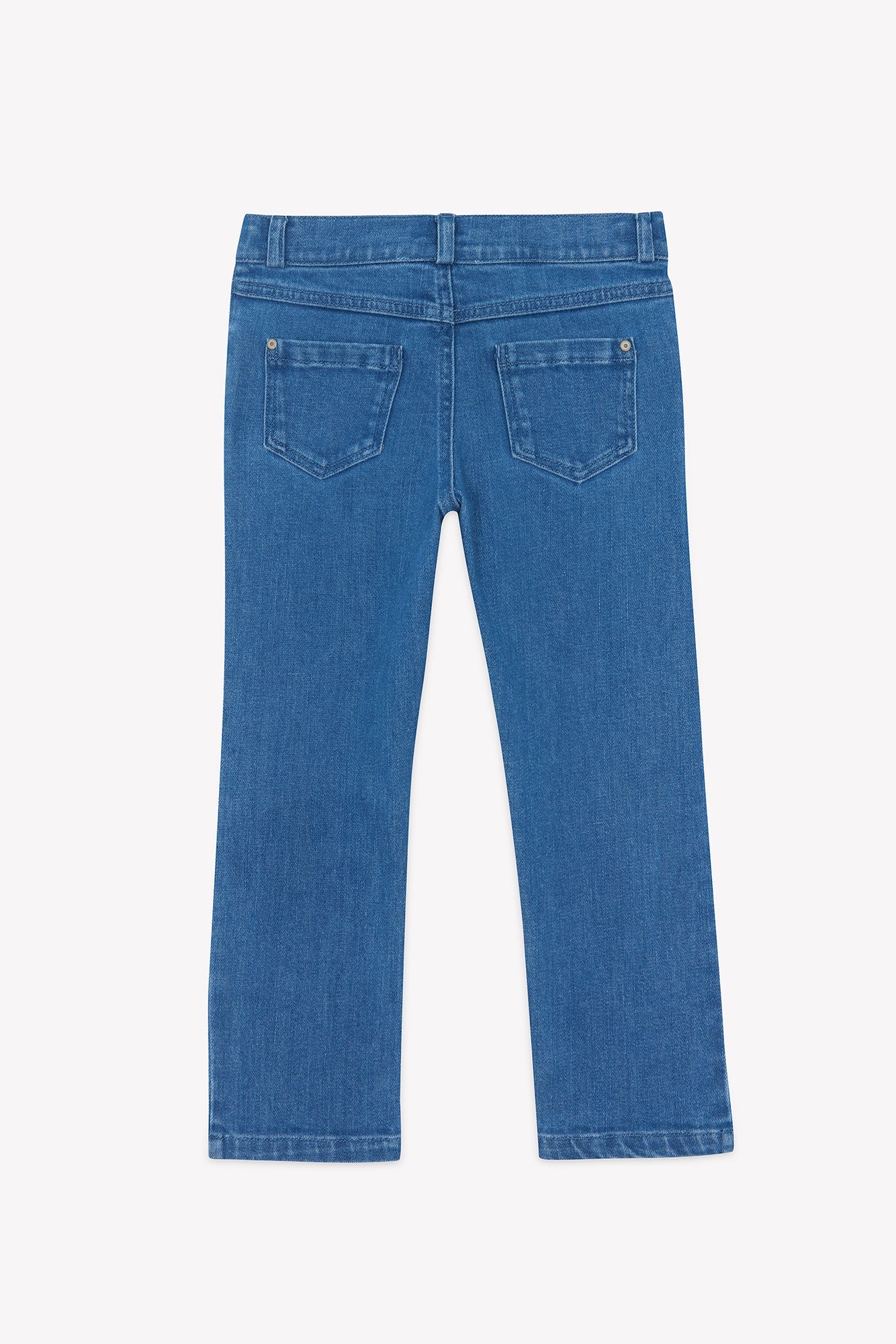 Boys’ Cotton Jeans by Tartine et Chocolat, shown from the back in blue denim with two rear pockets and belt loops, feature a versatile straight-leg design. Laid flat on a white background, these classic jeans offer comfort and durability.