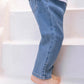 A little explorer wearing Tartine et Chocolat Baby Boys’ and Boys’ John Blue Jeans is walking up white stairs barefoot, paired with a crisp white shirt.