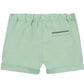 The Tartine et Chocolat Baby Boys’ and Boys’ Short in light green cotton features an elastic waistband, rolled hems, and a small back pocket for practical seaside style, displayed against a white background.