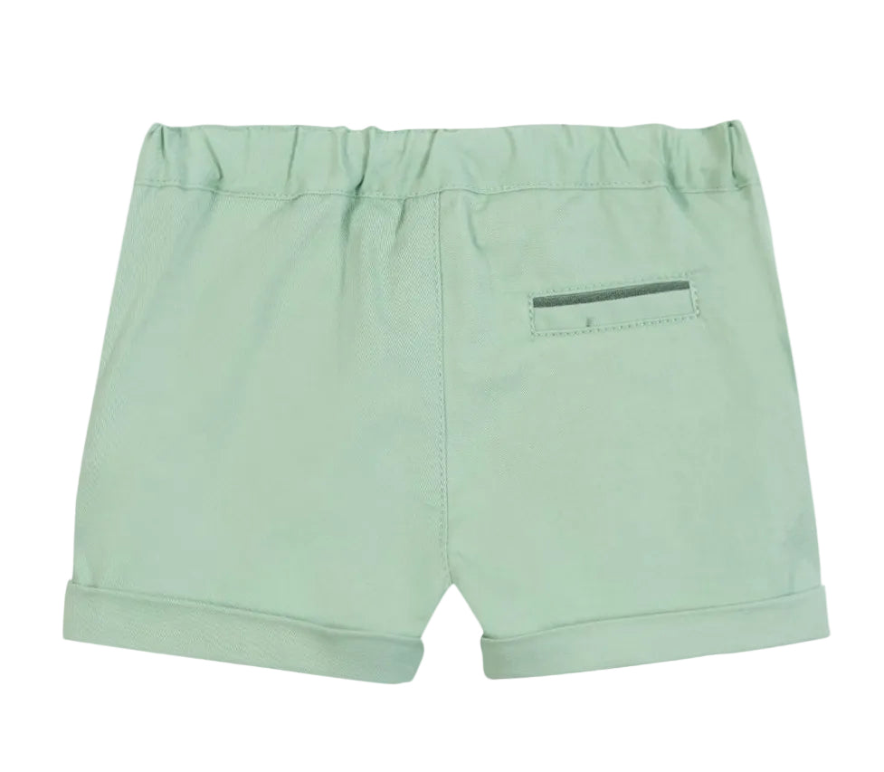 The Tartine et Chocolat Baby Boys’ and Boys’ Short in light green cotton features an elastic waistband, rolled hems, and a small back pocket for practical seaside style, displayed against a white background.