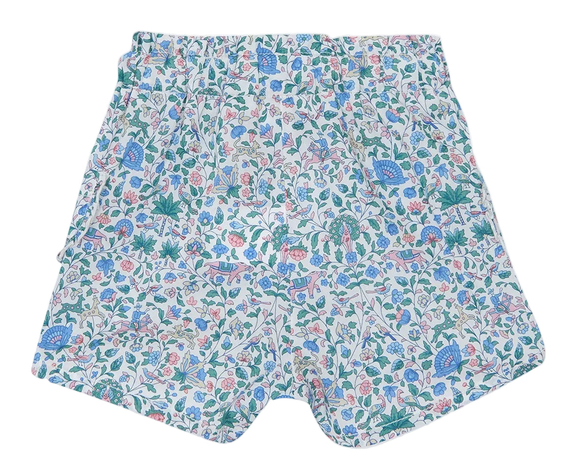 Tartine et Chocolat’s Baby Girls’ and Girls’ Liberty Shorts, summer-ready cotton shorts adorned with a charming floral print featuring pink, blue, and green flowers and leaves on a white background, shown laid flat on a white surface.