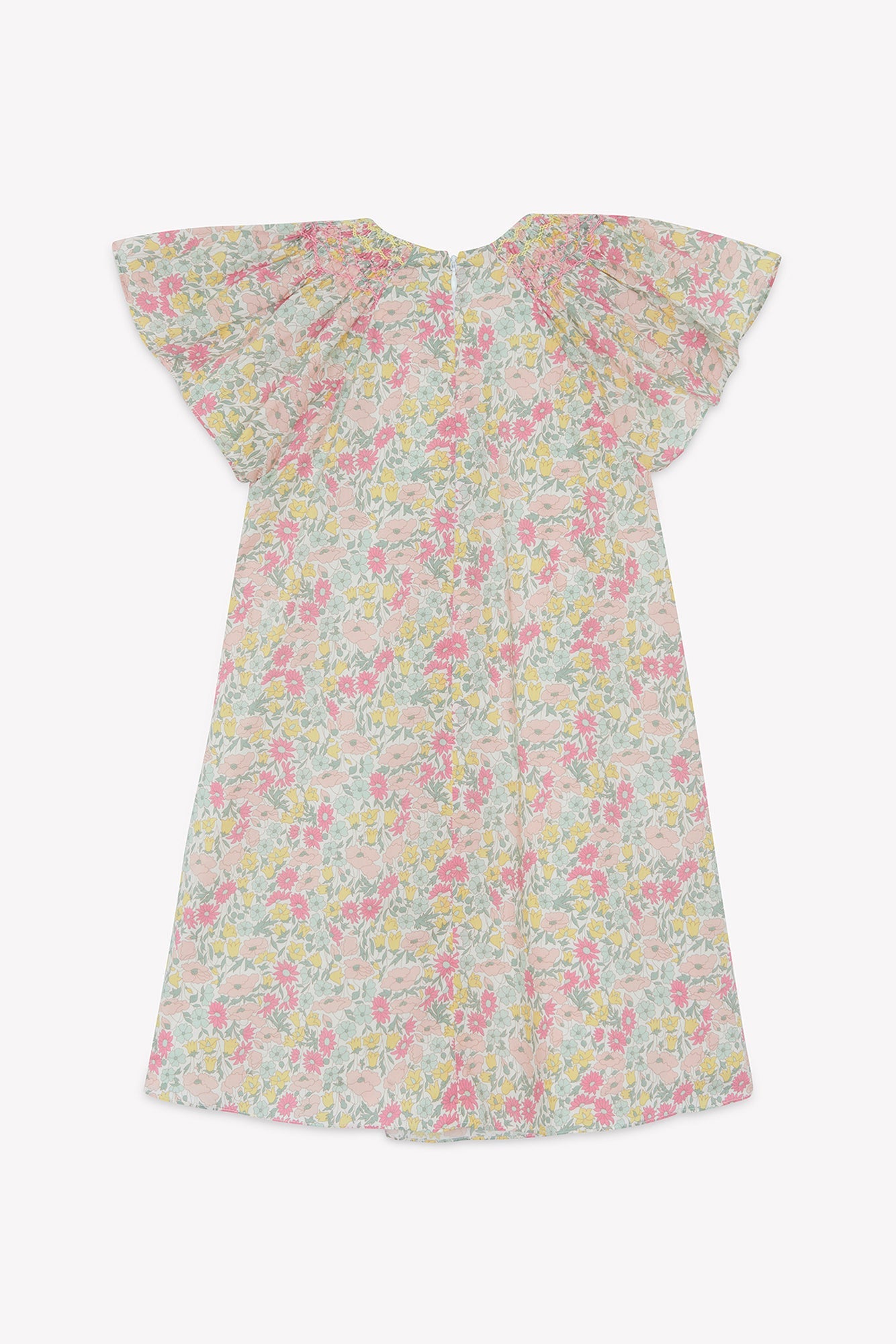The Tartine et Chocolat Girls’ Liberty Print Dress, shown on a plain white background, is a short-sleeve cotton dress with a pastel floral Liberty print, featuring wide flutter sleeves, a smocked collar, and a loose knee-length fit.
