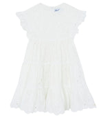 Tartine et Chocolat Girls’ Openwork Dress features delicate eyelet embroidery, ruffled short sleeves, and a scalloped hem. This charming white summer dress is perfect for warm-weather occasions and is displayed on a plain background.