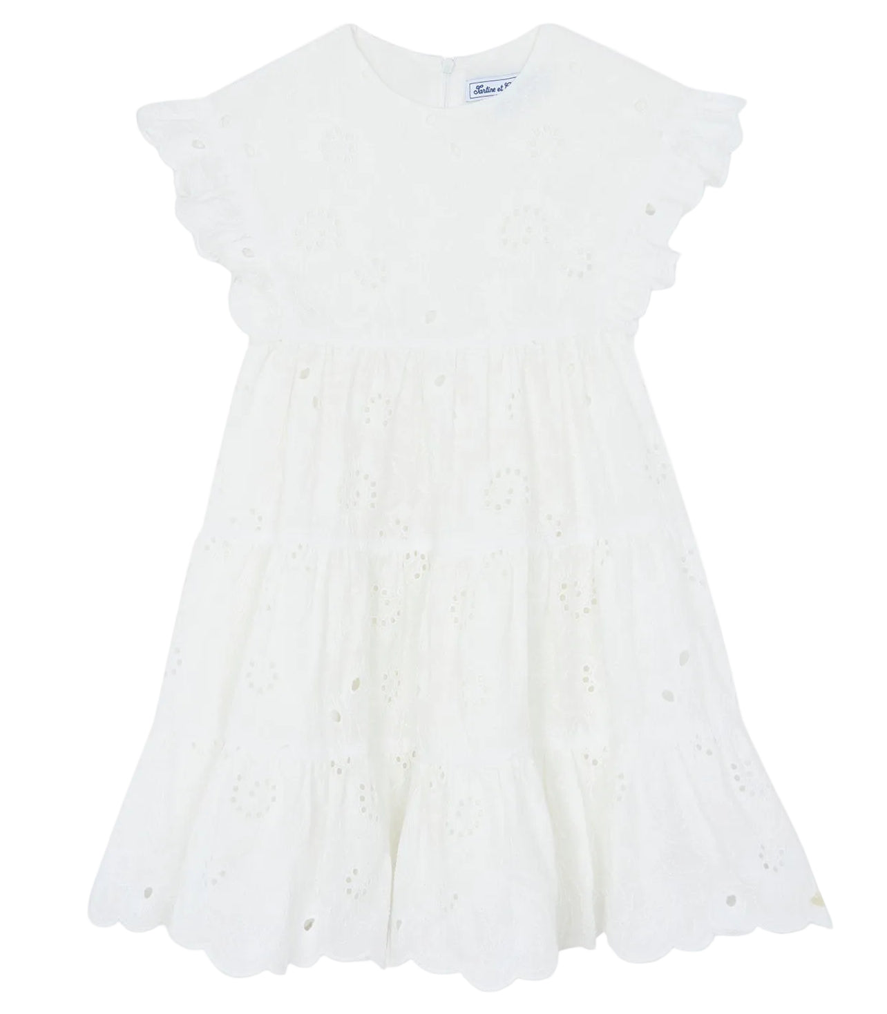 Tartine et Chocolat Girls’ Openwork Dress features delicate eyelet embroidery, ruffled short sleeves, and a scalloped hem. This charming white summer dress is perfect for warm-weather occasions and is displayed on a plain background.