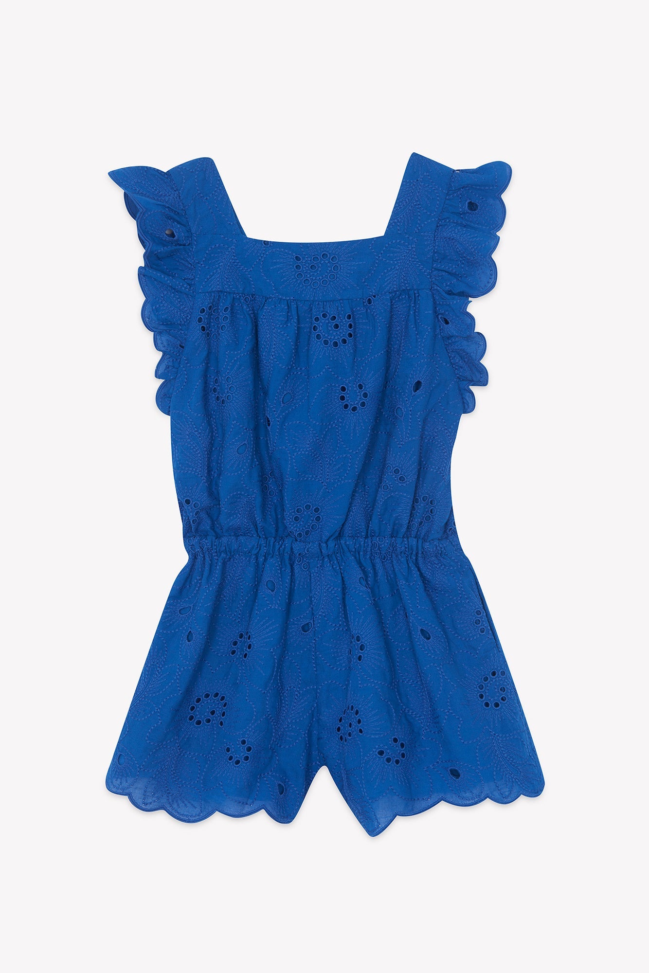 The Tartine et Chocolat Girls’ Openwork Short Jumpsuit features a blue openwork pattern, ruffled flutter sleeves, a square neckline, elastic waistband, and scalloped edges, shown against a white background.