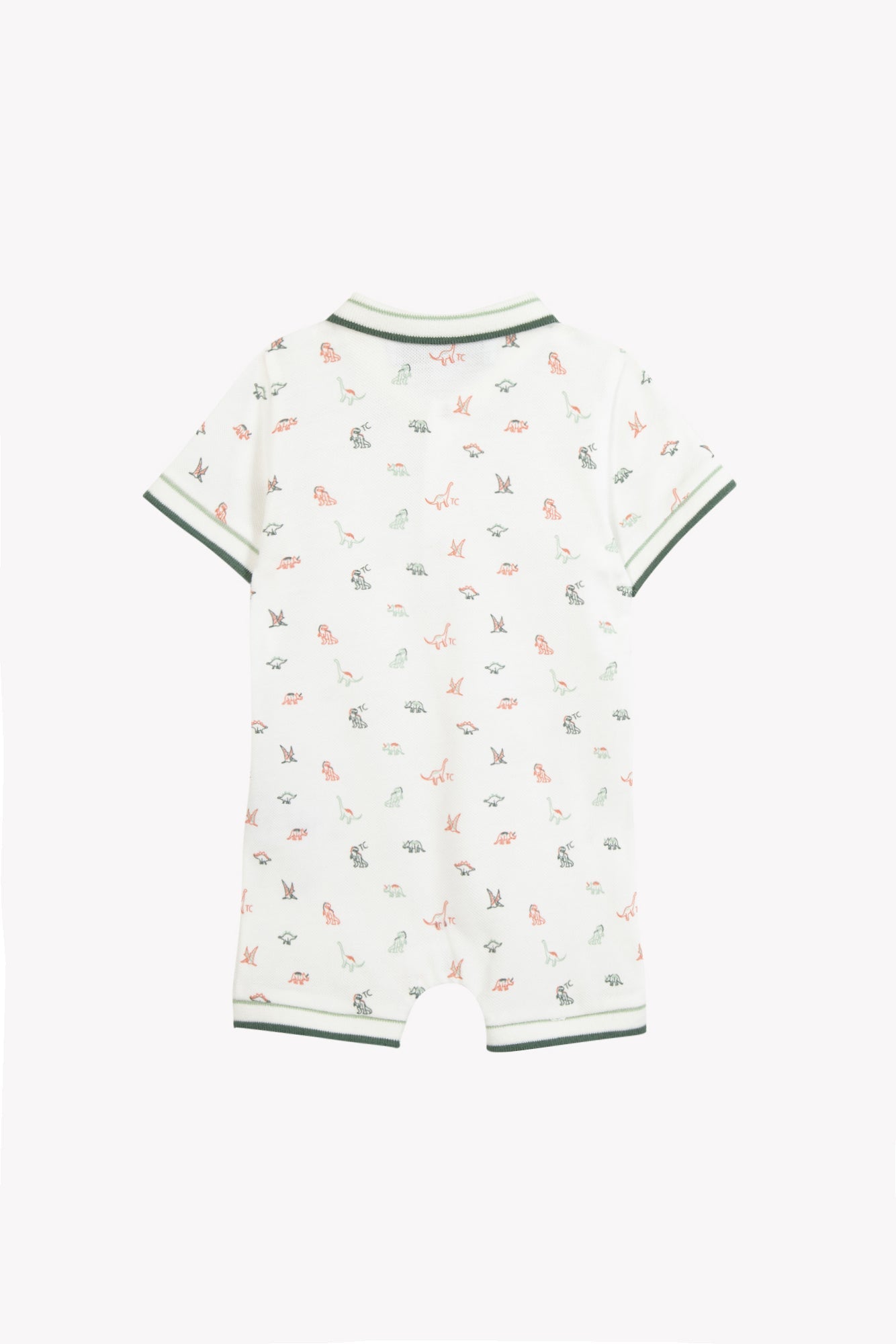 The Tartine et Chocolat Baby Boys’ Short Jumpsuit showcases a charming white design adorned with playful green and orange dinosaur prints. It features short sleeves and soft green trim accenting the collar, sleeves, and leg openings. Crafted for comfort, this jumpsuit is presented on a plain white background.