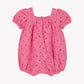 The Tartine et Chocolat Baby Girls’ English Embroidery Bubble features a charming pink design with puffed short sleeves, an elastic square neckline, and delicate cherry embroidery. Intricate English embroidery enhances this adorable cotton jumpsuit, making it a sweet outfit for baby girls and beautifully presented against a plain white background.