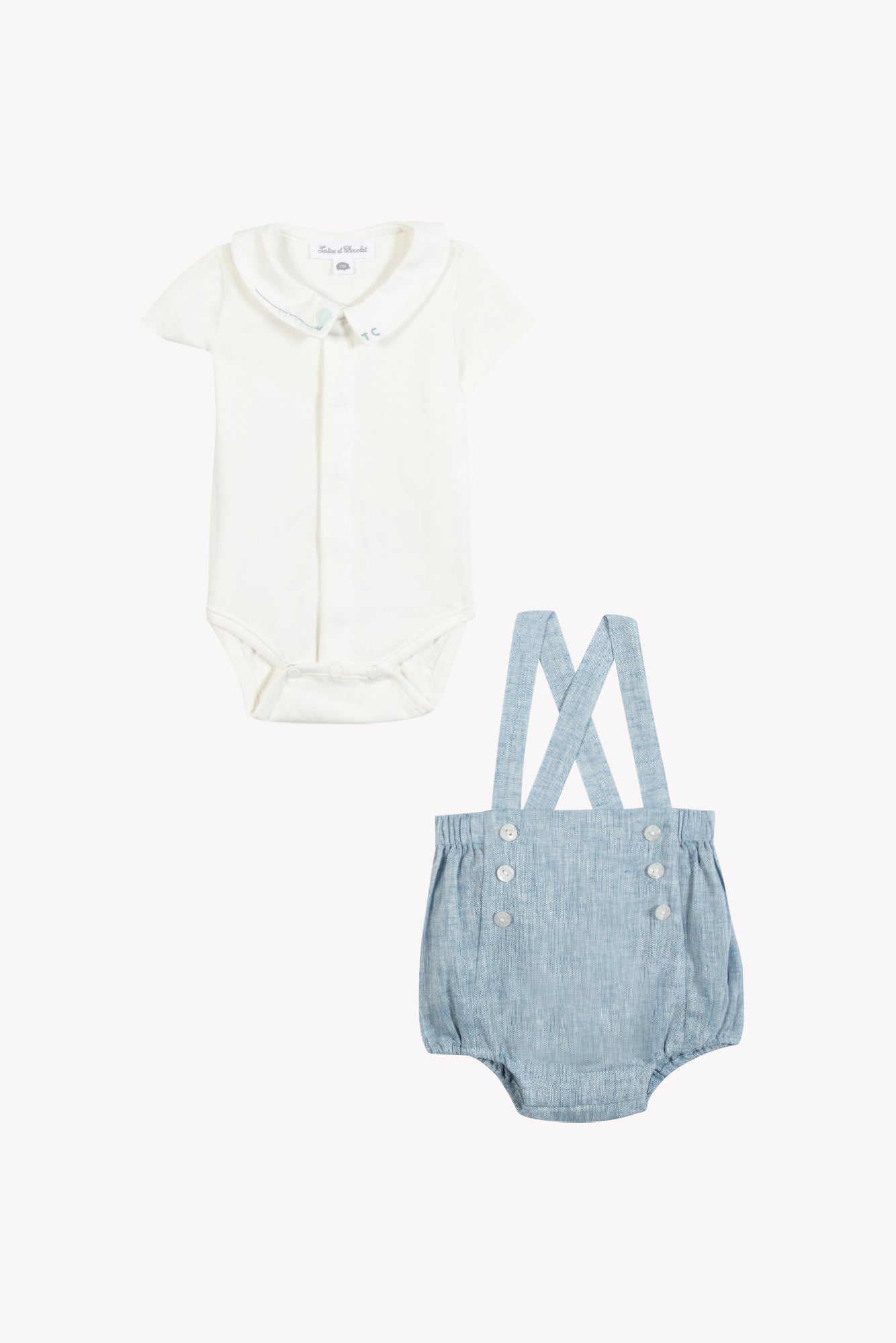 Dress your little one in the Baby Boys’ Pointed Collar Overall Outfit from Tartine et Chocolat, featuring a crisp white short-sleeve bodysuit with a pointed collar paired with light blue suspender shorts. The dungaree-style shorts are accented with front buttons and delicately embroidered hot air balloons, adding a playful touch to this charming ensemble.