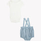 Tartine et Chocolat Baby Boys’ Pointed Collar Overall Outfit, featuring a crisp white short-sleeve bodysuit paired with blue chambray suspender bloomers, displayed on a plain background—a charming ensemble perfect for any occasion.