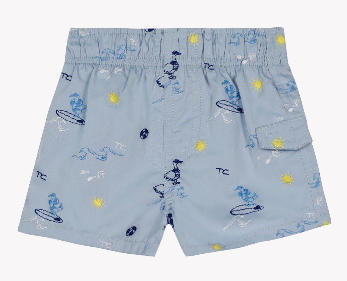Discover the Tartine et Chocolat Baby Boys’ and Boys’ Swim Short in light blue, featuring an elasticated waistband and a cheerful surfer and sun print—ideal for fun-filled beach days. Thoughtfully designed with a right-side pocket and a small front hem slit for extra comfort.