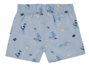 Tartine et Chocolat Baby Boys’ and Boys’ Swim Short in light blue, featuring an elasticated waistband and playful cartoon prints of ducks, surfboards, suns, waves, and beach balls in blue, yellow, and white—ideal for fun-filled days at the beach.