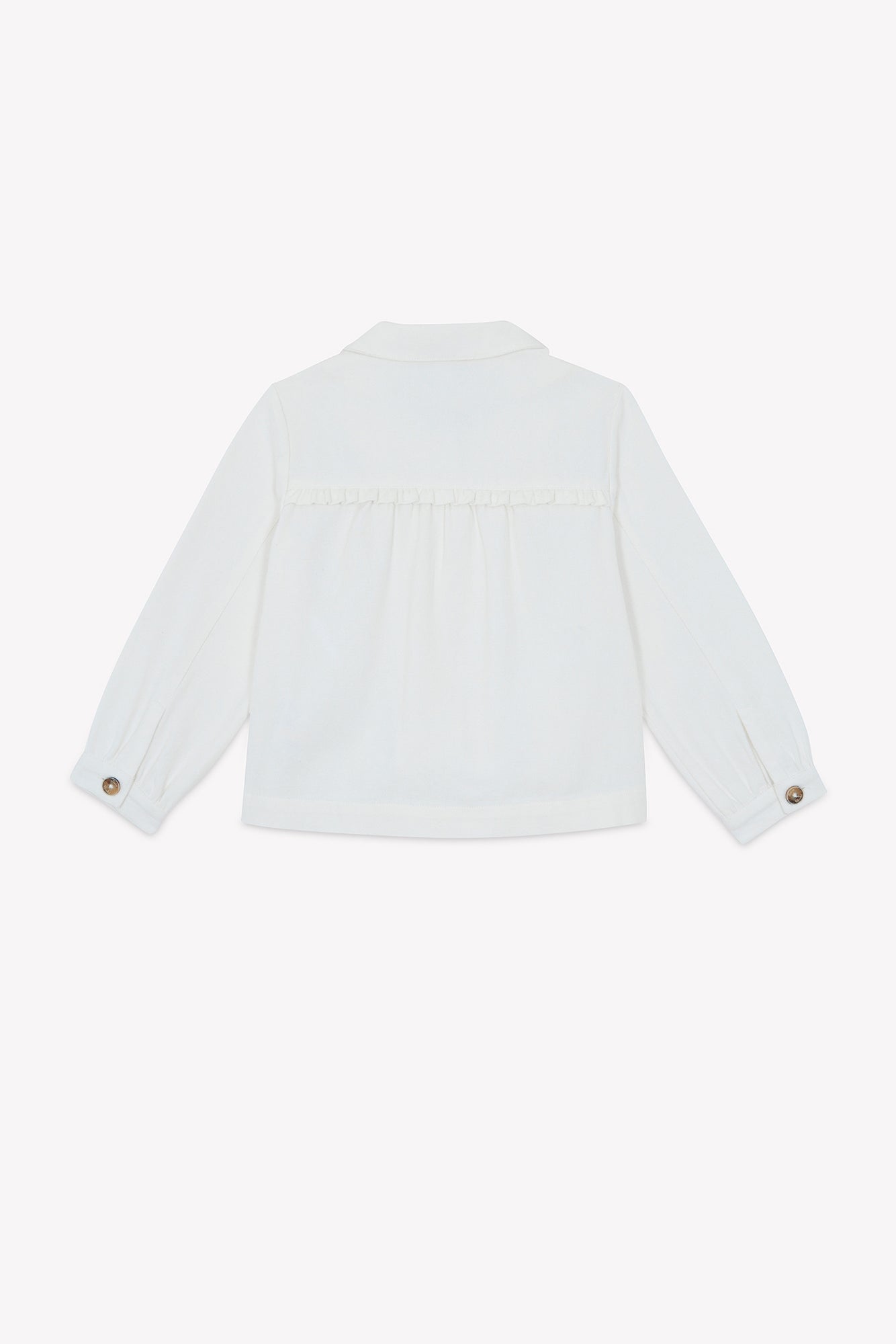 Back view of the Tartine et Chocolat Girls’ Cotton Jacket, featuring long sleeves with buttoned cuffs and a gathered section below the yoke, complemented by subtle ruffled detailing, displayed against a plain background.