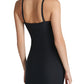 A person models the Commando Zone Smoothing Full Slip—a fitted, black, spaghetti strap dress with targeted compression—shown from the back against a plain light background.