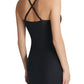 A woman is shown from the back wearing the Zone Smoothing Full Slip by Commando, a black fitted dress with crisscross straps that features targeted compression for a smooth, sculpted silhouette.