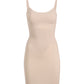 The Commando Zone Smoothing Full Slip is a beige, sleeveless bodycon dress with thin straps and targeted compression for a smooth silhouette, shown against a plain white background.